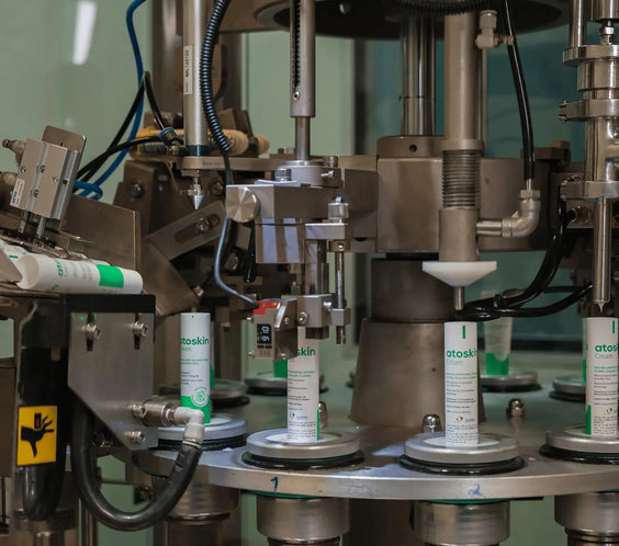 Automated production line filling Atoskin Cream tubes – high-quality manufacturing process for eczema and sensitive skin products.