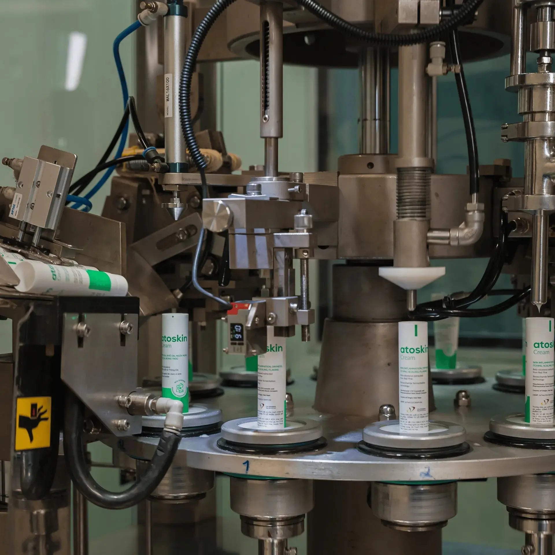 Automated production line filling Atoskin Cream tubes – high-quality manufacturing process for eczema and sensitive skin products.